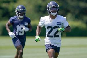 Seattle Seahawks rookie cornerback Tre Brown (22) runs with wide receiver Penny Hart (19) during NFL football practice Thursday, July 29, 2021, in Renton, Wash. (AP Photo/Ted S. Warren)