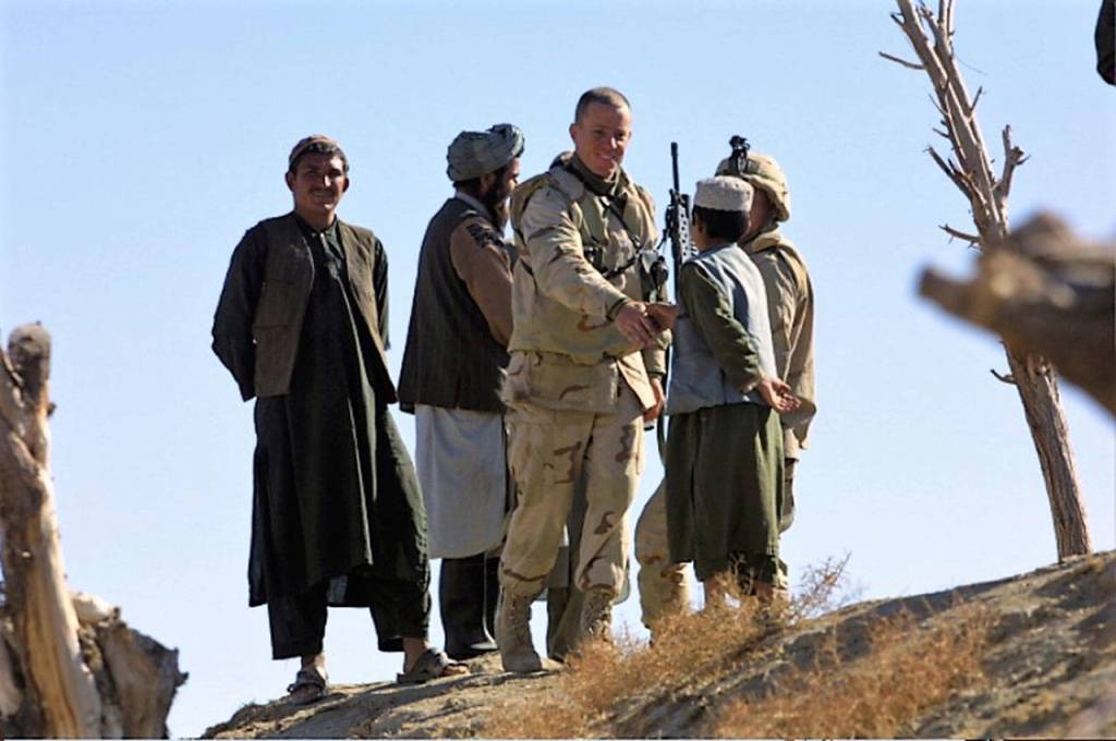 Will Lennon greets an Afghan child during his tour in Afghanistan shortly after 9/11. (Contributed photo)