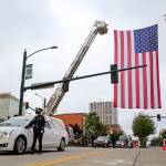 Officers escort symbolic remains of Officer Charlie Joe Cortez Tuesday afternoon at the Angel of the Winds Arena in Everett on August 17, 2021.  (Kevin Clark / The Herald)