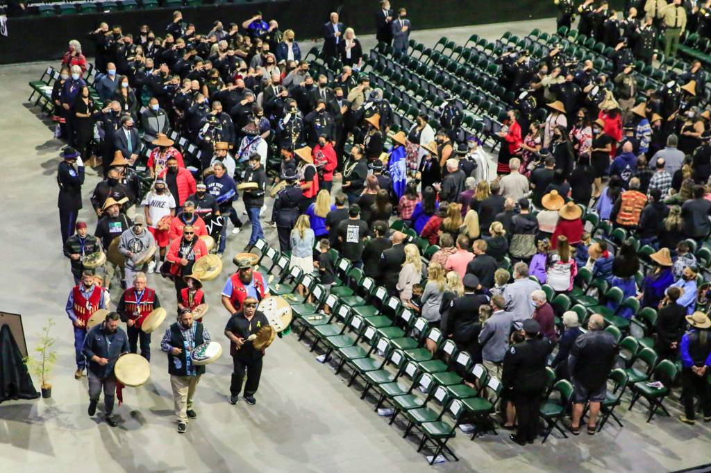 Members of the Tulalip Tribes start of the memorial service for Officer Charlie Joe Cortez Tuesday afternoon at the Angel of the Winds Arena in Everett on August 17, 2021.  (Kevin Clark / The Herald)