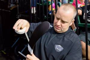 Longtime Everett Silvertips equipment manager James Stucky tapes up a hockey stick. (Everett Silvertips)