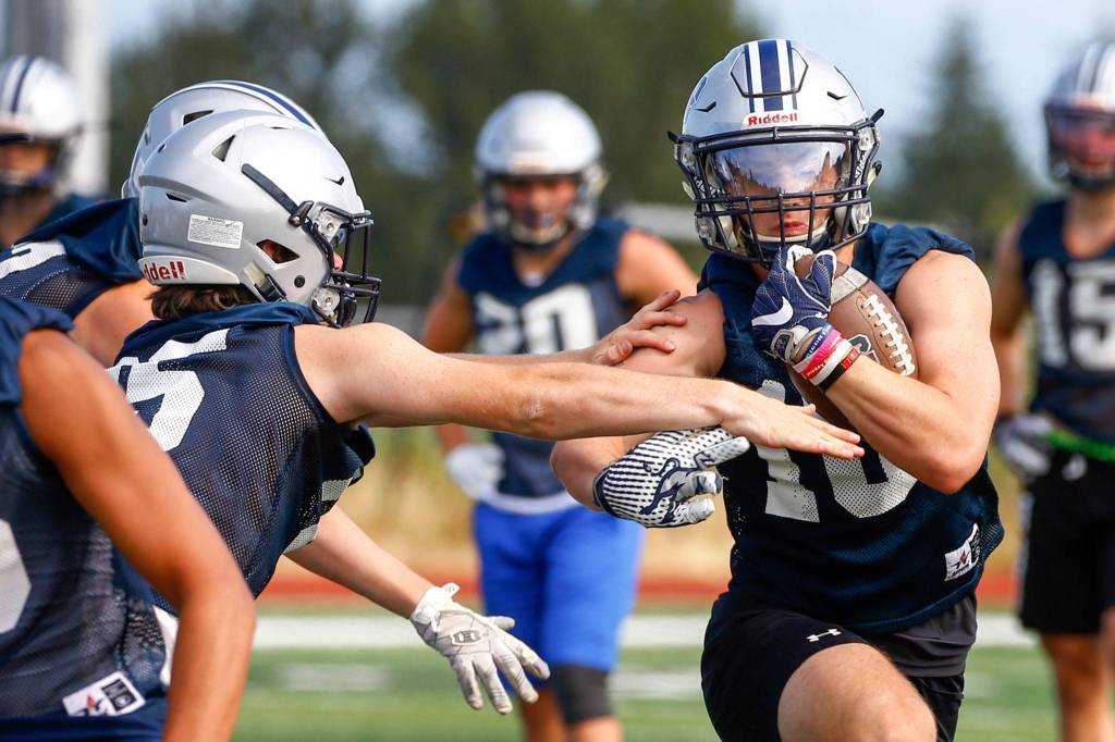 Ryan King rushes during practice Wednesday afternoon at Glacier Peak High School in Snohomish. (Kevin Clark / The Herald)