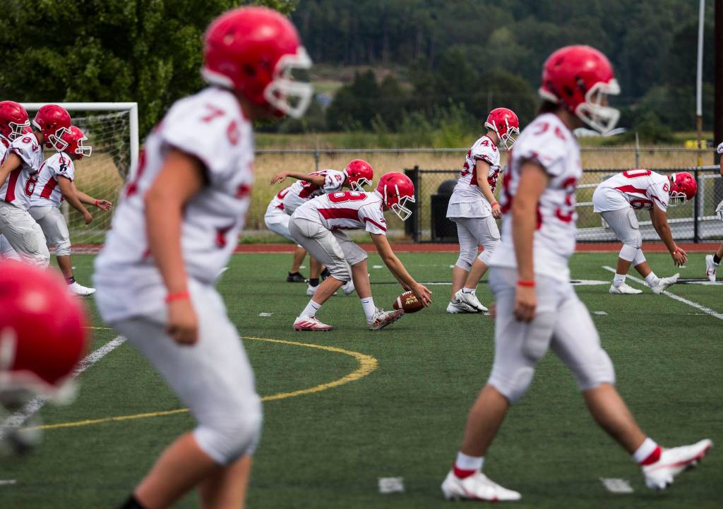 The Marysville Pilchuck football team stretches during practice on Thursday in Marysville. (Olivia Vanni / The Herald)