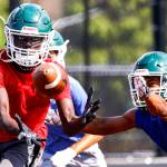 Ruot Deng makes a reception with Nathaniel Marinez defending during practice at Thursday afternoon at Edmonds-Woodway High School in Edmonds on August 19, 2021.  (Kevin Clark / The Herald)