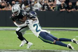 Seattle Seahawks cornerback Tre Flowers (21) tackles Las Vegas Raiders wide receiver DJ Turner (19) during the first half of an NFL preseason football game, Saturday, Aug. 14, 2021, in Las Vegas. (AP Photo/Rick Scuteri)