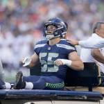 Seattle Seahawks Ben Burr-Kirven is driven off the field on a cart after an injury during the first half of a preseason game against the Denver Broncos on Saturday in Seattle. (AP Photo/John Froschauer)