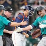 Seattle Mariners' Kyle Seager, right, celebrates with Ty France (23) after both scored on Seager's three-run home run against the Houston Astros during the 11th inning of a baseball game Sunday, Aug. 22, 2021, in Houston. (AP Photo/David J. Phillip)