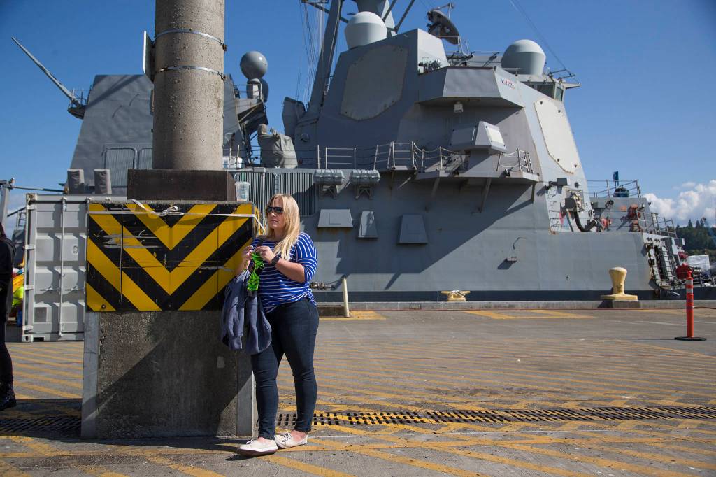 Jessica Norris knits a sock as she waits to see Ensign James Norris of the USS John Paul Jones, which arrived in Everett on Monday. (Andy Bronson / The Herald)