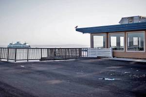 A small amount of debris covers the ground where Ivar's tables and chairs had been set up in the parklet where the former Mukilteo Ferry Landing was located on Wednesday, Aug. 25, 2021 in Mukilteo, Wash. (Olivia Vanni / The Herald)