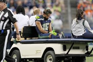 Seattle Seahawks wide receiver John Ursua is taken off the field on a cart after an injury during the first half of the team's NFL preseason football game against the Denver Broncos, Saturday, Aug. 21, 2021, in Seattle. (AP Photo/Stephen Brashear)