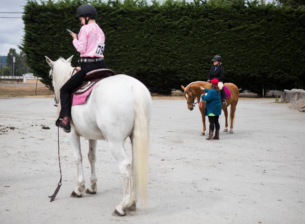 People wait to get into the arena with their horses during opening day of the Evergreen State Fair on Thursday in Monroe. (Olivia Vanni / The Herald)