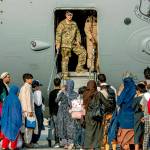 In this Aug. 22, 20121, image provided by the U.S. Air Force, service members prepare to board evacuees onto a C-17 Globemaster lll on Sunday, Aug. 22, 2021, at Al Udeid Air Base, Qatar. The Department of Defense is committed to supporting the U.S. State Department in the departure of U.S. and allied civilian personnel from Afghanistan, and to evacuate Afghan allies to safety. (Airman 1st Class Kylie Barrow/U.S. Air Force via AP)