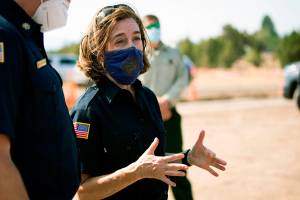 FILE - In this June 28, 2021, file photo, Oregon Gov. Kate Brown visits the Bly Fire Camp on the southern edge of the Bootleg Fire, in Klamath County, Ore. People in Oregon, regardless of vaccination status, will be once again be required wear masks in most public outdoor settings, including large outdoor events where physical distancing is not possible, beginning Friday, Aug. 27, 2021. (Arden Barnes/The Herald And News via AP, File)