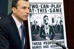 FILE - In this Wednesday, Feb. 26, 2020, file photo, Raymond Duda, then-FBI Special Agent in Charge in Seattle, speaks as he stands next to a poster that was mailed earlier in the year to the home of Chris Ingalls, an investigative reporter with KING-TV in Seattle, during a news conference in Seattle. Cameron Shea, an organizer of a neo-Nazi campaign to threaten journalists and Jewish activists in three states was sentenced Tuesday, Aug, 24, 2021, to three years in prison after apologizing for what he did and saying he’s a changed man. (AP Photo/Ted S. Warren, File)
