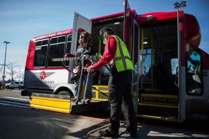 Leigh Spruce gets off of Everett Para Transit at the Everett Mall on Thursday, March 11, 2021 in Everett, Wa. (Olivia Vanni / The Herald)