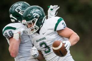 Edmonds-Woodway's Ryan Fahey celebrates a touchdown with Isaac Wicks during the game on Friday, March 26, 2021 in Edmonds, Wa. (Olivia Vanni / The Herald)