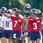 Seahawks players, including quarterbacks Russell Wilson (3) and Geno Smith (7), wave to fans after a practice on Aug. 11, 2021, in Renton. (AP Photo/Elaine Thompson)
