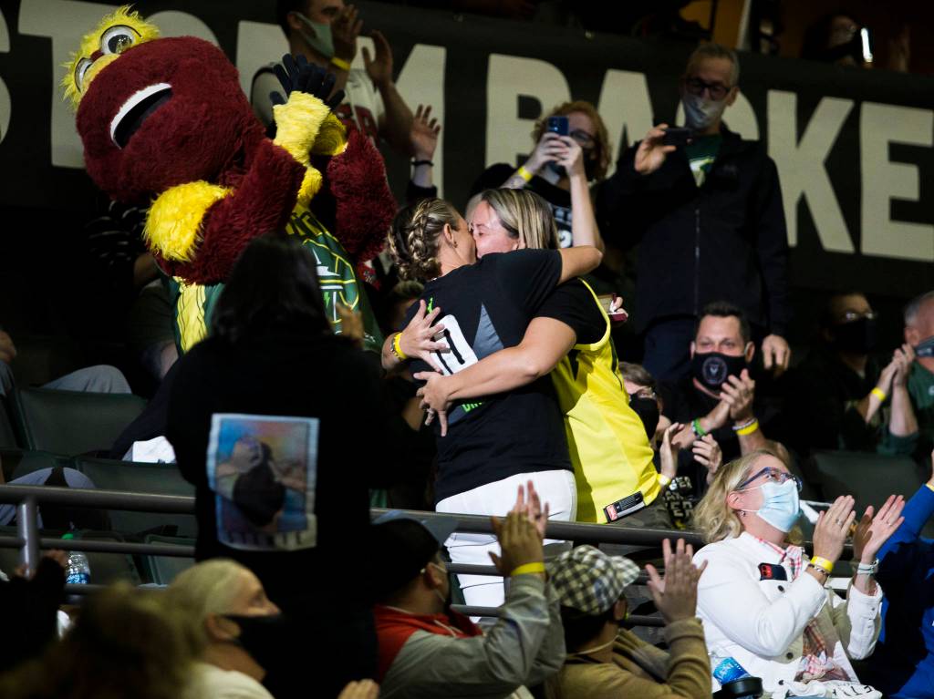 A couple kisses after an engagement during the game against the Chicago Sky at Angel of the Winds Arena on Friday, Aug. 27, 2021 in Everett, Wash. (Olivia Vanni / The Herald)