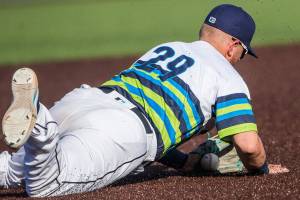 AquaSox's Tyler Keenan dives for the ball during the game against the Dust Devils on Sunday, May 16, 2021 in Everett, Wash.