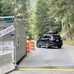 A vehicle turns away Monday morning from Olympic National Parks Heart O the Hills entry station after Hurricane Ridge Road was closed due to a suspected armed man fleeing into the woods. (Paul Gottlieb / Peninsula Daily News)