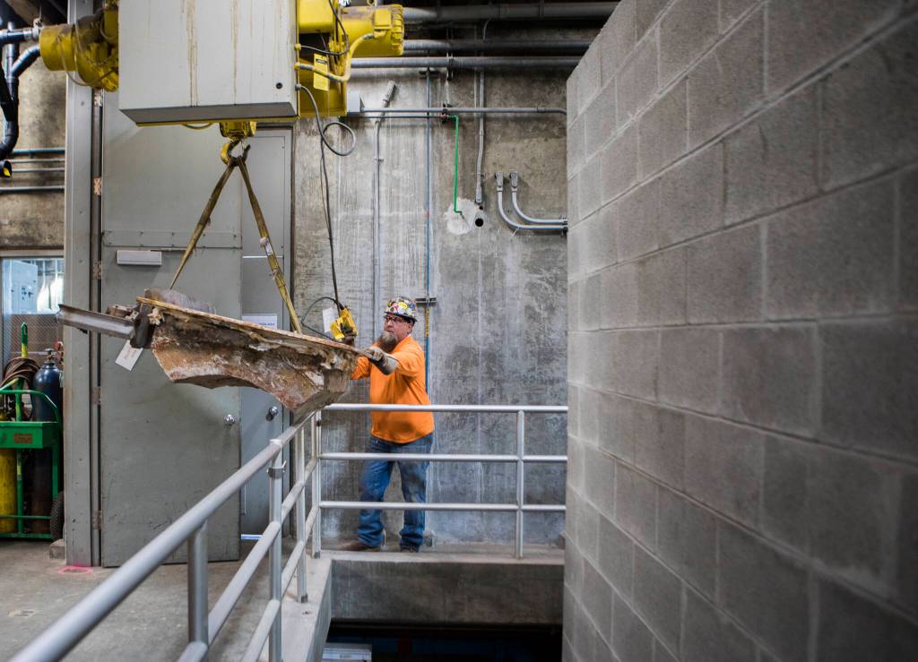 A worker disassembles a fluidized bed incinerator at the Edmonds Wastewater Treatment Plant last Thursday in Edmonds. (Olivia Vanni / The Herald)