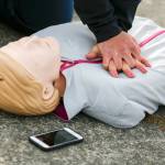 Capt. Kate Songhurst keeps time with the PulsePoint app during a CPR demonstration Tuesday at Kasch Park in Everett. (Kevin Clark / The Herald)