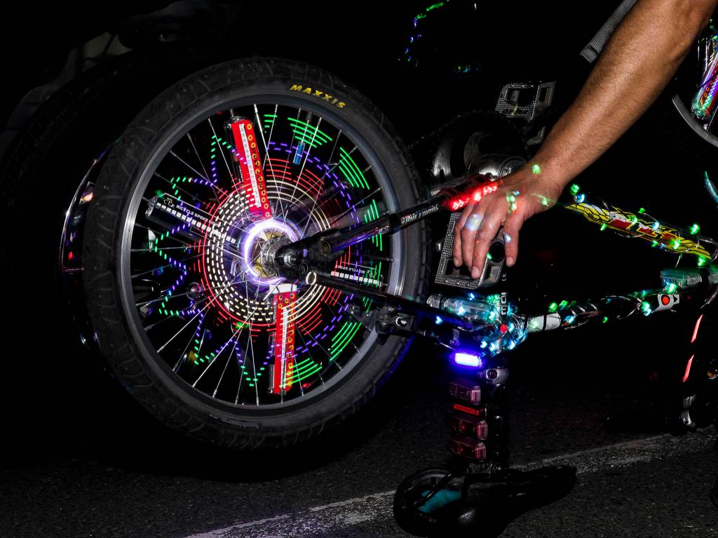 Lights illuminate the spokes of a bike Saturday in Everett. (Olivia Vanni / The Herald)