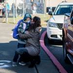Elizabeth Panagos kisses her son, Paxton, through her mask as she drops him off for his first day of kindergarten at Mountain Way Elementary in Granite Falls on Wednesday. (Olivia Vanni / The Herald)