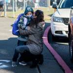 Elizabeth Panagos kisses her son Paxton through her mask as she drops him off for his first day of kindergarten at Mountain Way Elementary on Wednesday, Sept. 1, 2021 in Granite Falls, Wa. (Olivia Vanni / The Herald)