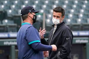 Seattle Mariners general manager Jerry Dipoto, right, talks with manager Scott Servais before the team's baseball game against the San Francisco Giants on Thursday, April 1, 2021, in Seattle. (AP Photo/Elaine Thompson)