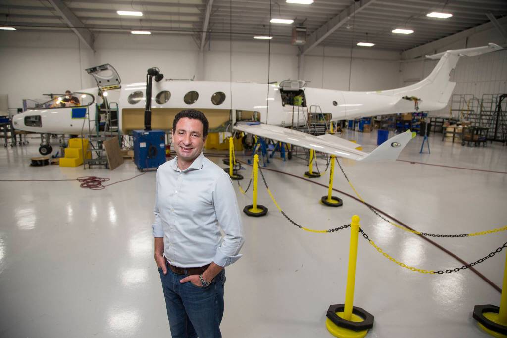 Eviation co-founder and CEO Omer Bar-Yohay stands by the companys all-electric plane, the Alice, at Eviations plant Sept. 8 in Arlington. (Andy Bronson / The Herald)