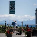 A couple looks out toward the water from Boy and Dog Park on Thursday, July 22, 2021 in Langley, Wash. (Olivia Vanni / The Herald)