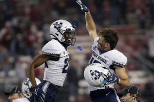 Utah State safety Dominic Tatum, left, and wide receiver Brandon Bowling celebrate the team's 26-23 win against Washington State in an NCAA college football game, Saturday, Sept. 4, 2021, in Pullman, Wash. (AP Photo/Young Kwak)