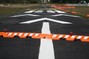 Its business as usual in spite of construction starting on the Harvey Airfield runway on Thursday, Sept. 9, 2021 in Snohomish, Washington.  Planes use the grass/dirt runway as the asphalt runway gets a new facelift. (Andy Bronson / The Herald)