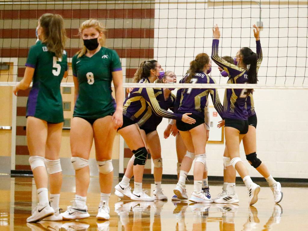 Lake Stevens celebrate a point against Edmonds-Woodway Tuesday night at Edmonds-Woodway High School in Edmonds on September 7, 2021. The Vikings won in straight sets. (Kevin Clark / The Herald)