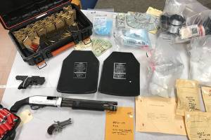 Some of what was recovered pictured above: guns, body armor plates, clear plastic bags with fentanyl and yellow envelopes with heroin.
