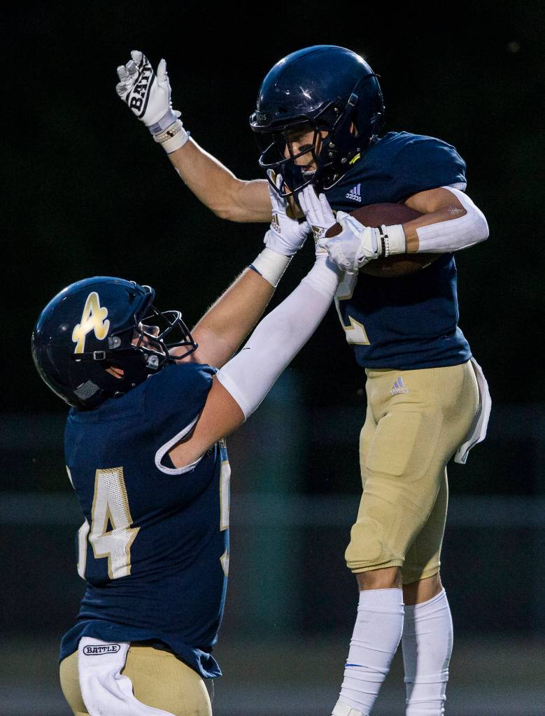 Arlingtons Levi Younger celebrates his touchdown with Nolan Welch during the game against Oak Harbor on Friday, Sept. 10, 2021 in Arlington, Wa. (Olivia Vanni / The Herald)