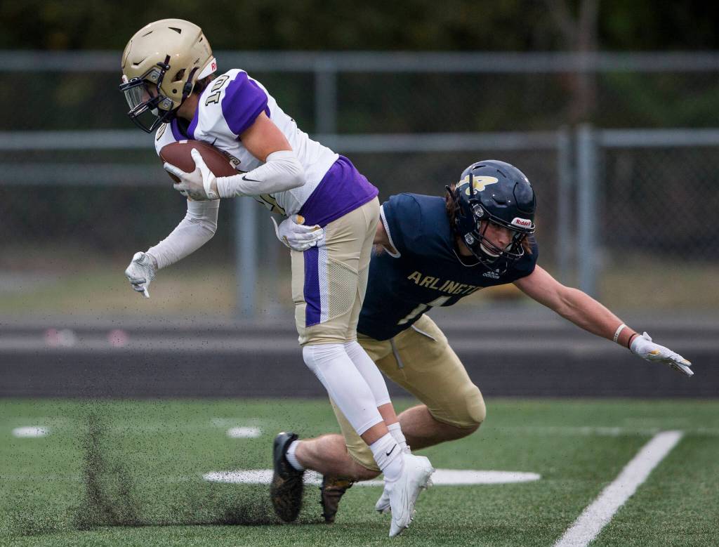 Arlingtons Hunter Eastman tackles Oak Harbors Brody Synder during the game on Friday, Sept. 10, 2021 in Arlington, Wa. (Olivia Vanni / The Herald)