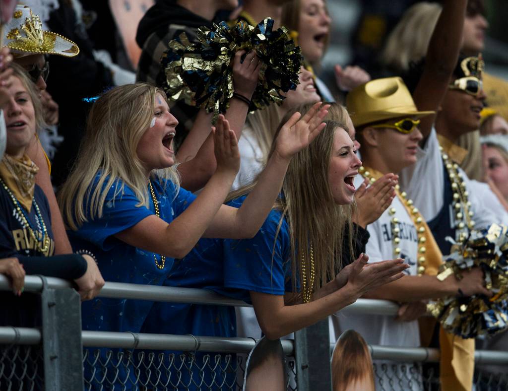 Arlington fans cheer during the game against Oak Harbor on Friday, Sept. 10, 2021 in Arlington, Wa. (Olivia Vanni / The Herald)