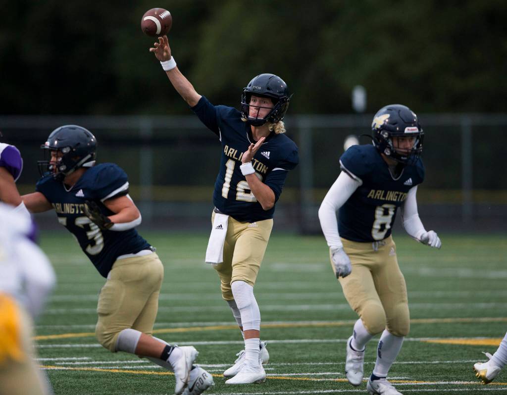 Arlingtons Trent Nobach throws the ball during the game against Oak Harbor on Friday, Sept. 10, 2021 in Arlington, Wa. (Olivia Vanni / The Herald)