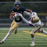 Arlingtons Elijah Jackson reaches out to block Oak Harbors Caden Ebai during the game on Friday, Sept. 10, 2021 in Arlington, Wa. (Olivia Vanni / The Herald)