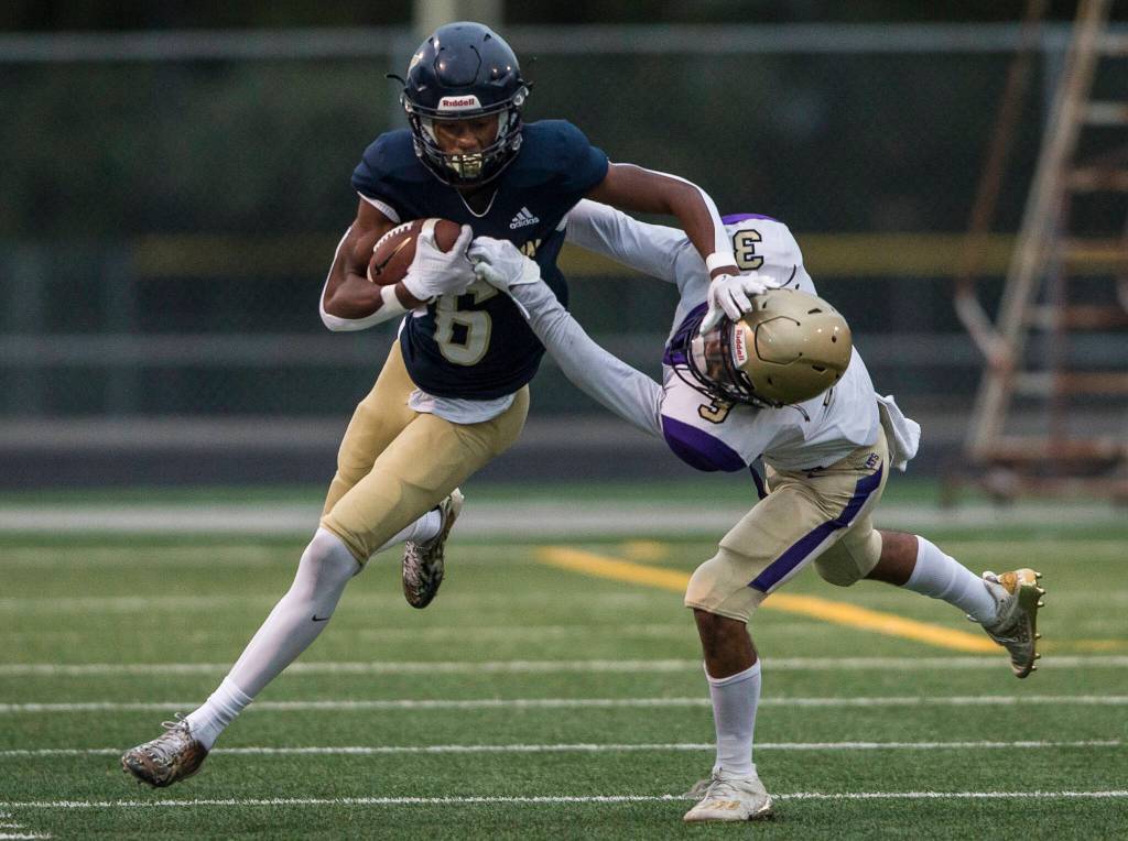 Arlingtons Elijah Jackson reaches out to block Oak Harbors Caden Ebai during the game on Friday, Sept. 10, 2021 in Arlington, Wa. (Olivia Vanni / The Herald)