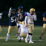Arlington players react to a false start by Oak Harbor during the game on Friday, Sept. 10, 2021 in Arlington, Wa. (Olivia Vanni / The Herald)