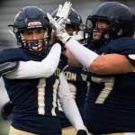 Arlingtons Trenton Lamie and Wyatt Tilton celebrate during the game against Oak Harbor on Friday, Sept. 10, 2021 in Arlington, Wa. (Olivia Vanni / The Herald)