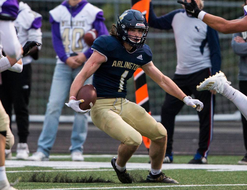 Arlingtons Hunter Eastman runs the ball during the game against Oak Harbor on Friday, Sept. 10, 2021 in Arlington, Wa. (Olivia Vanni / The Herald)