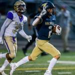 Arlington's Levi Younger holds up two fingers as he runs the ball into the end zone for his second touchdown of the night during the game against Oak Harbor on Friday, Sept. 10, 2021 in Arlington, Wa. (Olivia Vanni / The Herald)