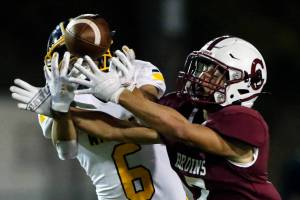 Mariners' Isaiah Cuellar, left, and Cascade's Zach Lopez reach for a pass intended for Lopez Friday evening at Everett Memorial Stadium on September 10, 2021. (Kevin Clark / The Herald)