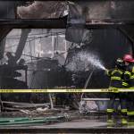 South County firefighters spray water into a business with fire damage at Plum Tree Plaza off of Highway 99 on Saturday, Sept. 11, 2021 in Edmonds, Wa. (Olivia Vanni / The Herald)