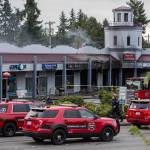 South County fire vehicles park along a closed portion of Highway 99 due to a fire at Plum Tree Plaza on Saturday, Sept. 11, 2021 in Edmonds, Wa. (Olivia Vanni / The Herald)