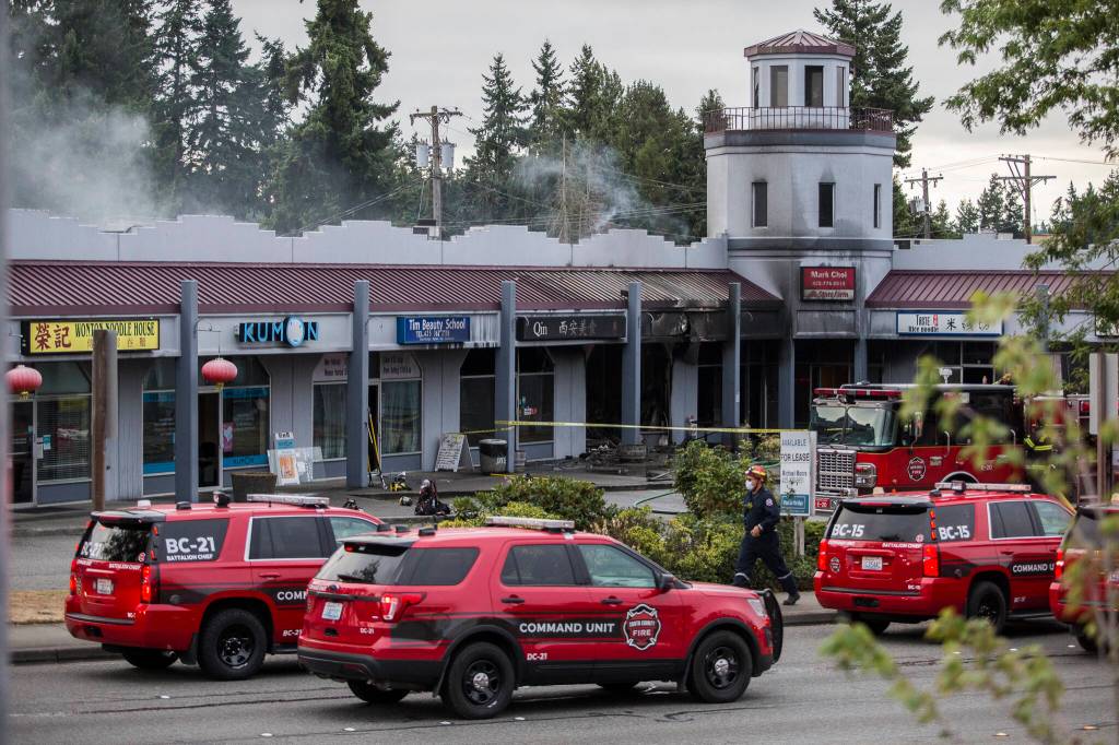 South County fire vehicles park along a closed portion of Highway 99 due to a fire at Plum Tree Plaza on Saturday, Sept. 11, 2021 in Edmonds, Wa. (Olivia Vanni / The Herald)